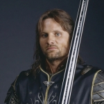 Aragorn, from Lord of the Rings, stands with a sword in clean cut knight tunic.